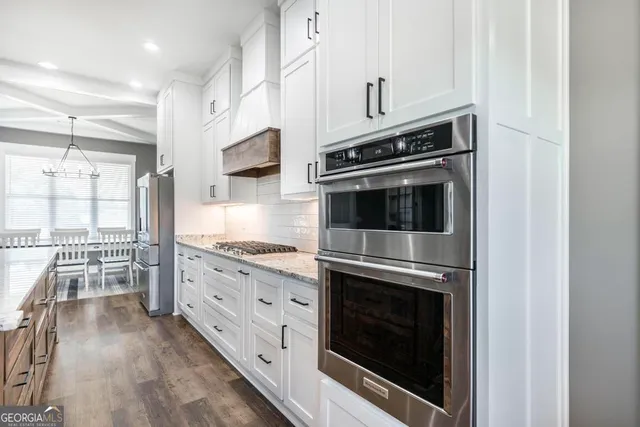 a kitchen with stainless steel appliances a stove microwave and cabinets