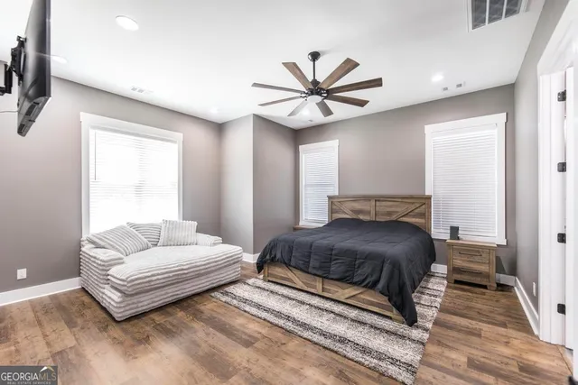 a bedroom with a large bed and a flat screen tv