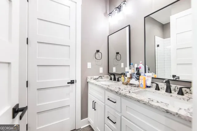 a bathroom with a granite countertop sink toilet and shower