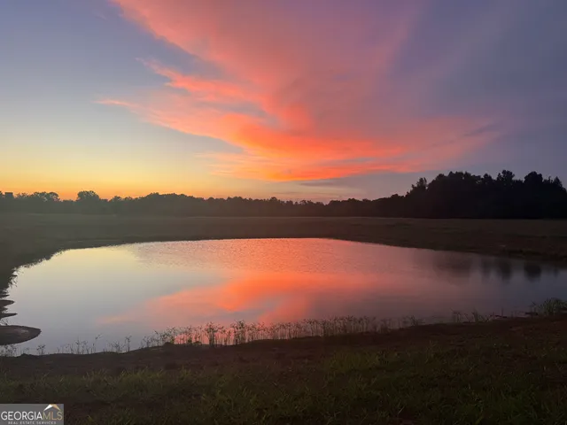 a view of a room with a table chair and a chandelier