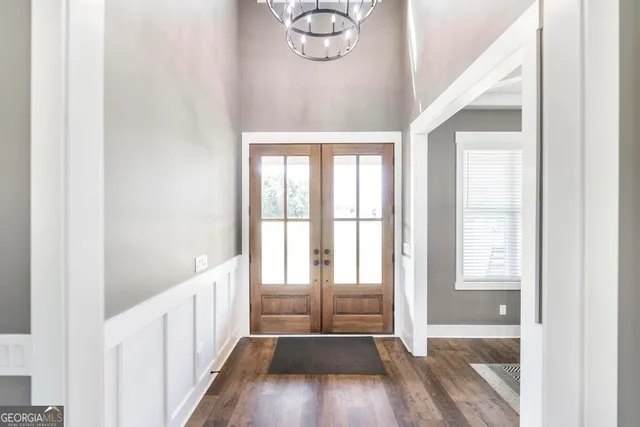 a view of a room with wooden floor and windows