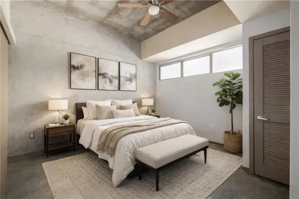 a bedroom with a large bed and a chandelier
