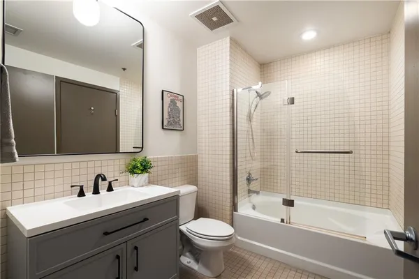 a bathroom with a sink toilet tub and shower