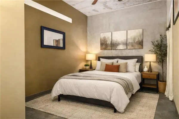 a bedroom with a bed and a painting on the wall
