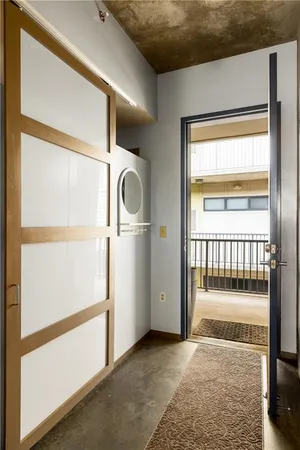 a view of a hallway with wooden floor and a window