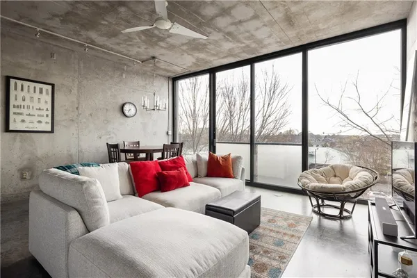 a living room with furniture and a large window