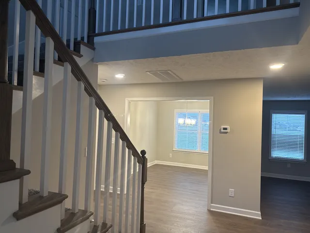 a view of an entryway with wooden floor and door