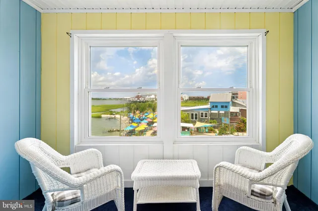 a view of a hallway with chairs and a window