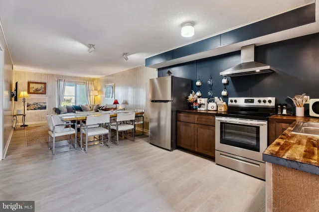 a kitchen with stainless steel appliances a refrigerator and a stove