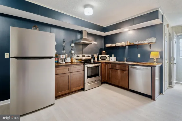 a kitchen with stainless steel appliances granite countertop a stove and a refrigerator