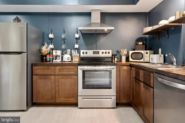 a kitchen with stainless steel appliances granite countertop a stove and a sink