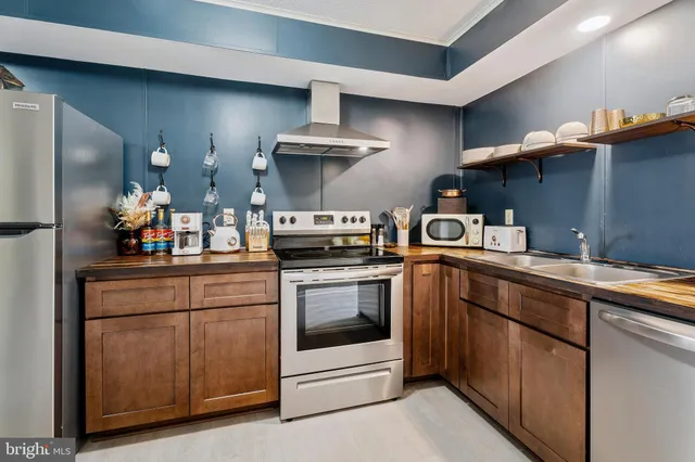 a stove top oven sitting inside of a kitchen