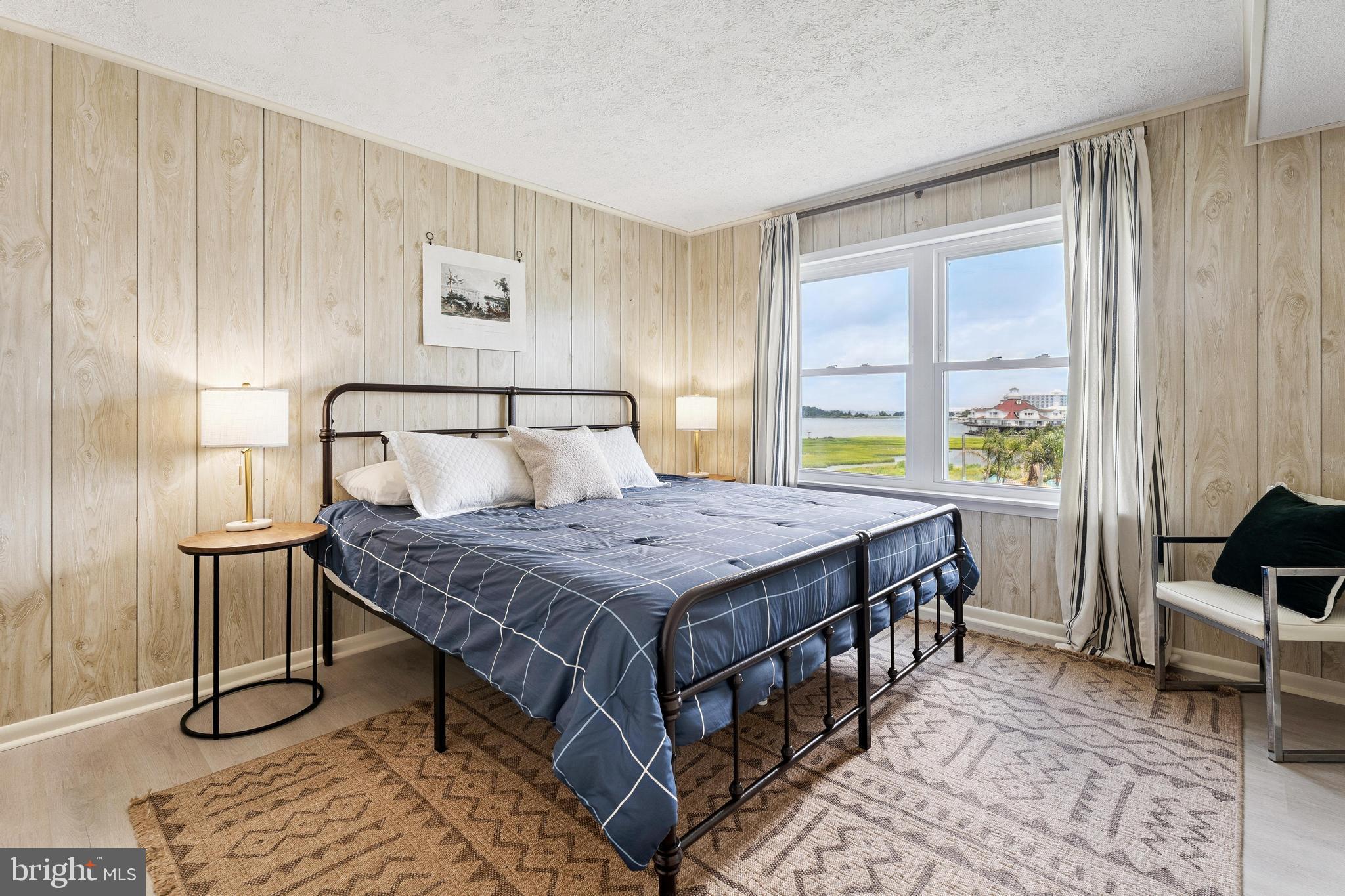 120 53rd Street, Unit H30102 Ocean City, MD 21842 - Photo 24 of 53 a bedroom with a bed and a table in it