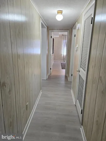 a bed sitting in a spacious bedroom next to a window