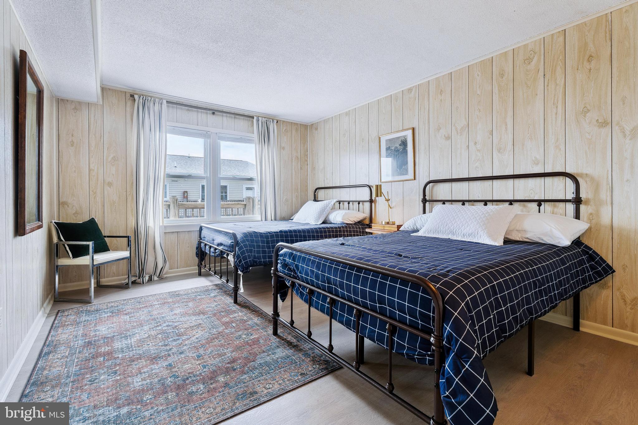 120 53rd Street, Unit H30102 Ocean City, MD 21842 - Photo 28 of 53 a bed sitting in a spacious bedroom next to a window