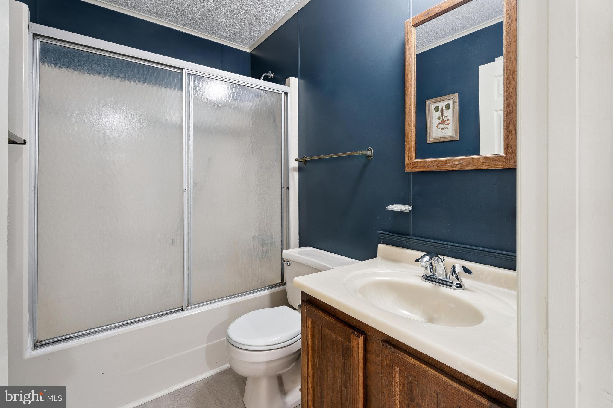 120 53rd Street, Unit H30102 Ocean City, MD 21842 - Photo 36 of 53 a bathroom with a sink and a mirror