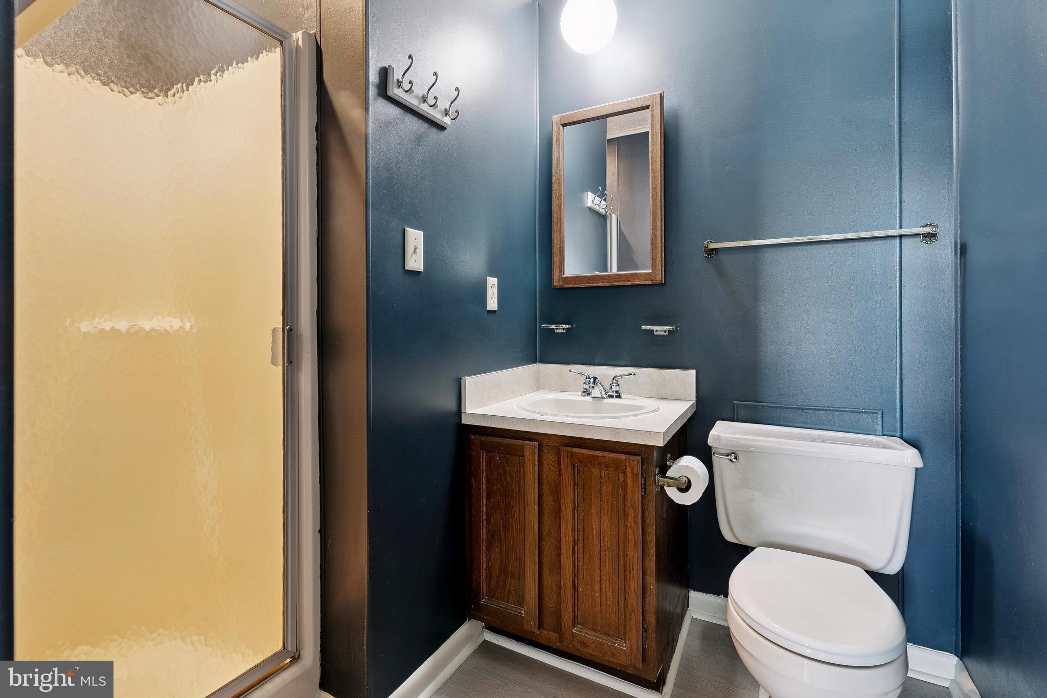 120 53rd Street, Unit H30102 Ocean City, MD 21842 - Photo 37 of 53 a bathroom with a toilet sink and mirror