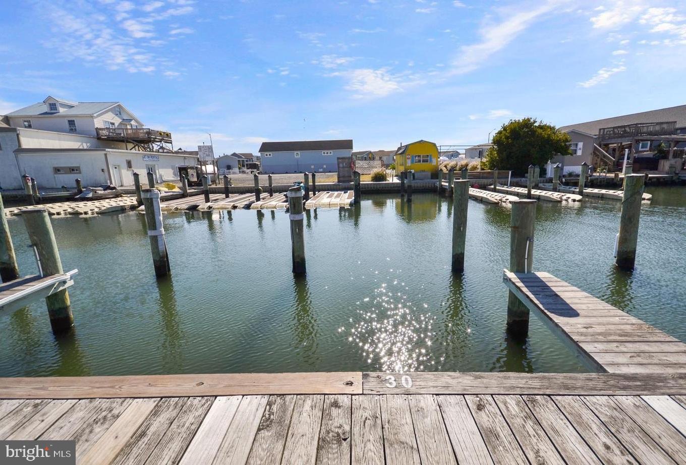 120 53rd Street, Unit H30102 Ocean City, MD 21842 - Photo 41 of 53 a view of a lake with boats and trees in the background