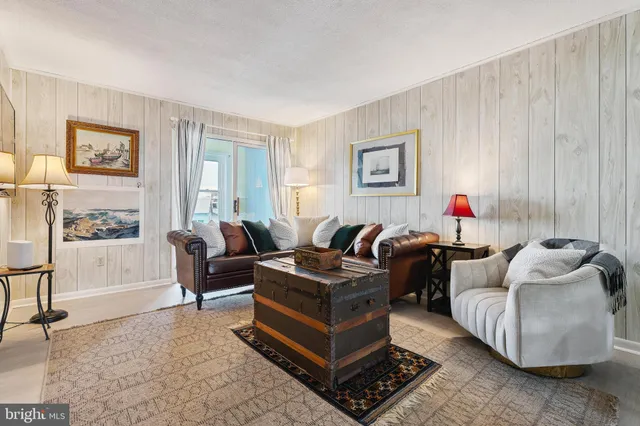 a blue couch sitting next to a window