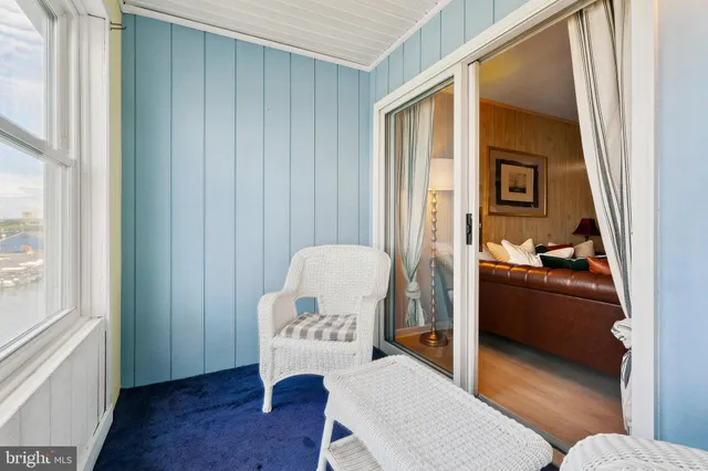 a view of a dining room with furniture wooden floor and a potted plant
