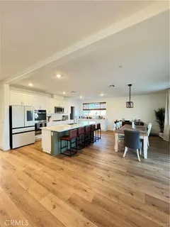 a living room with furniture and kitchen view