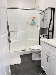 a bathroom with a toilet and a shower