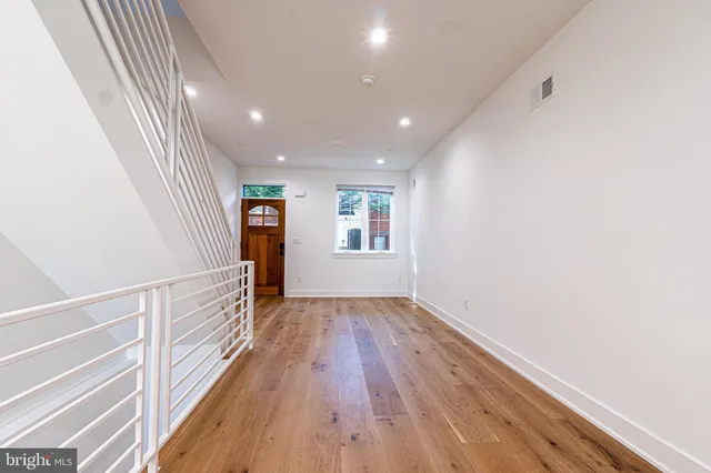 a view of a hallway with wooden floor