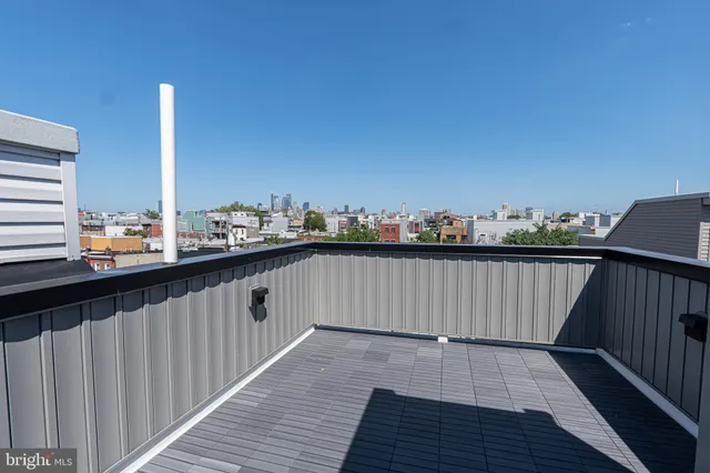 a view of balcony with wooden floor and fence