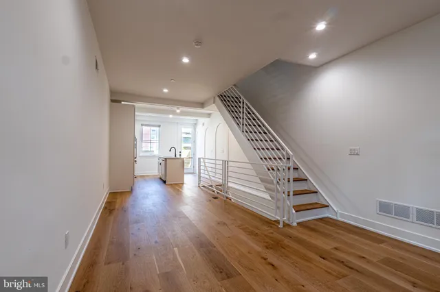 a view of entryway and hall with wooden floor