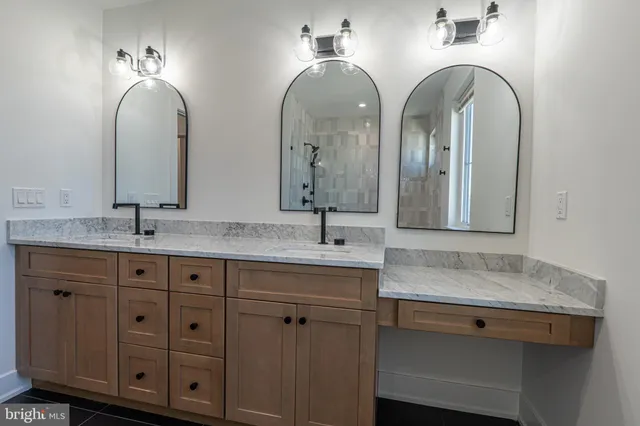 a bathroom with double sink and a mirror