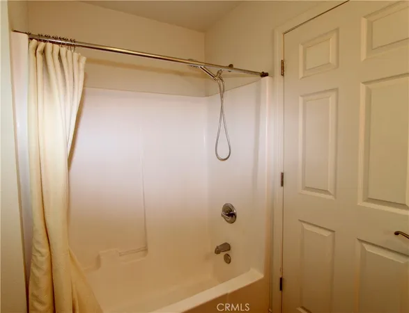 a bathroom with a shower and a glass door