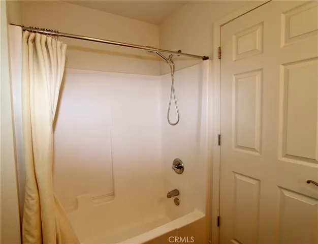 a bathroom with a shower and a glass door