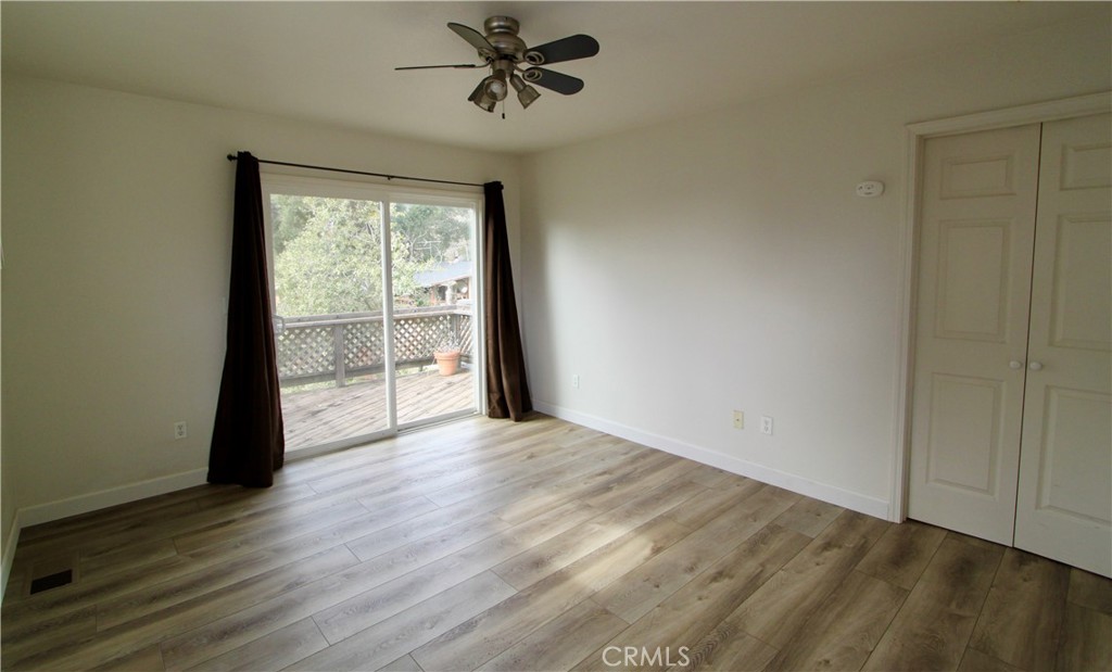 3085 Gardner Road Nice, CA 95464 - Photo 17 of 25 a view of an empty room with wooden floor and a window