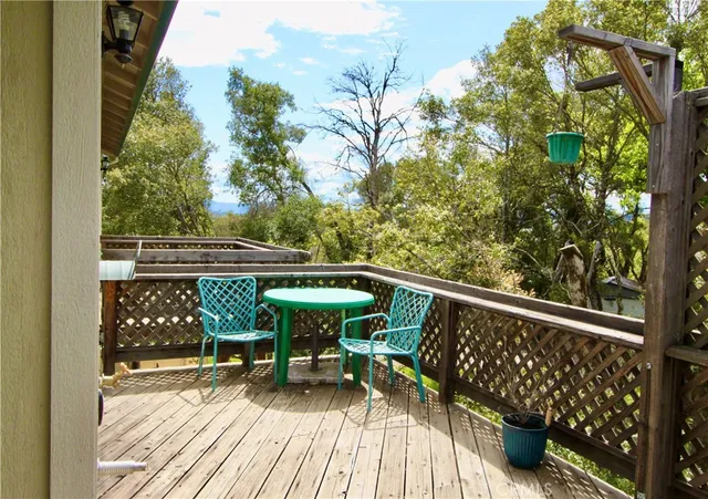 a view of balcony with wooden floor and outdoor seating