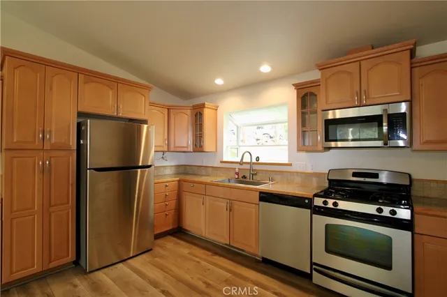 a kitchen with a refrigerator sink and microwave