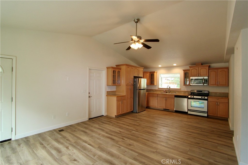 3085 Gardner Road Nice, CA 95464 - Photo 4 of 25 a large kitchen with cabinets wooden floor and stainless steel appliances