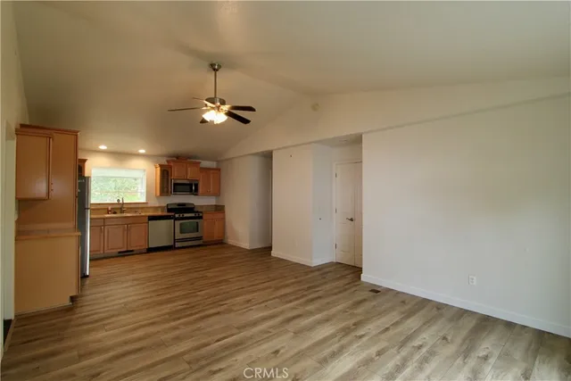 a view of kitchen with sink microwave and stove top oven