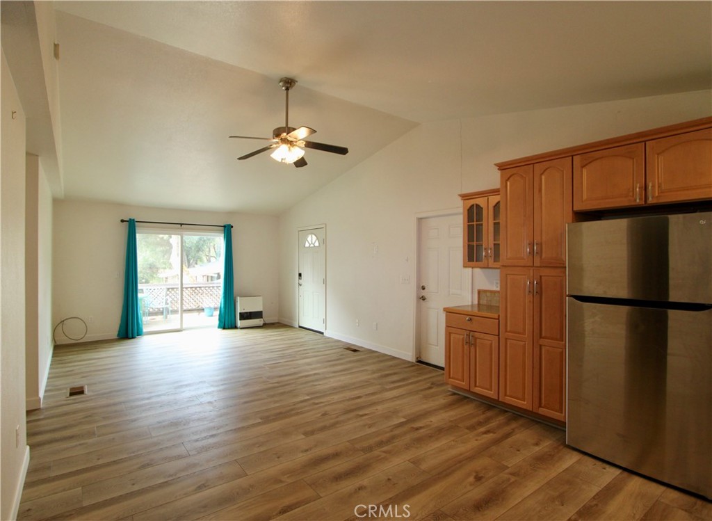 3085 Gardner Road Nice, CA 95464 - Photo 6 of 25 a view of a kitchen with a refrigerator a ceiling fan and wooden floor