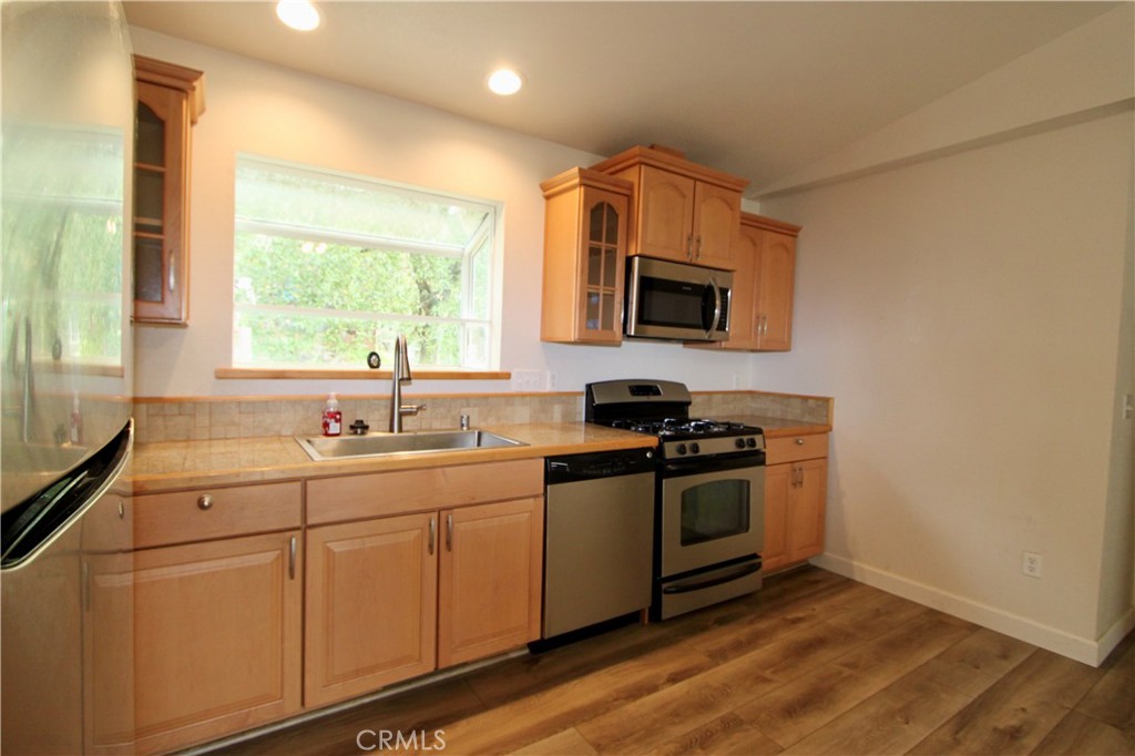 3085 Gardner Road Nice, CA 95464 - Photo 7 of 25 a kitchen with stainless steel appliances white cabinets a sink and a stove