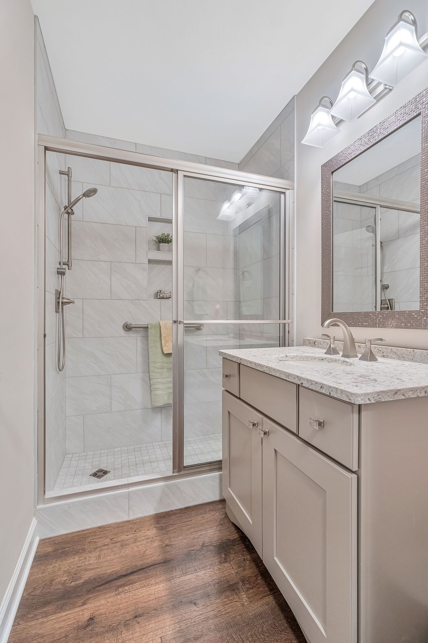 529 General George Patton Road Nashville, TN 37221 - Photo 20 of 28 a bathroom with a granite countertop sink a mirror and a shower