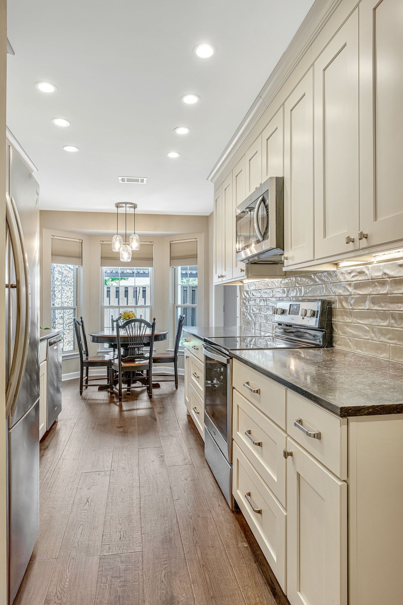 529 General George Patton Road Nashville, TN 37221 - Photo 3 of 28 a kitchen with stainless steel appliances granite countertop a stove a sink dishwasher and a refrigerator with wooden floor