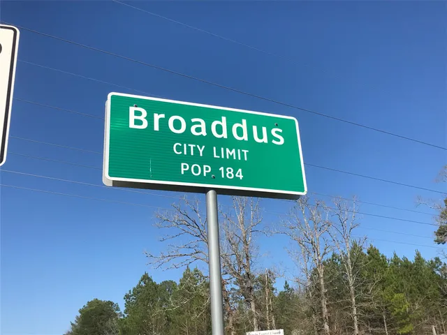 a sign that is on a brick wall