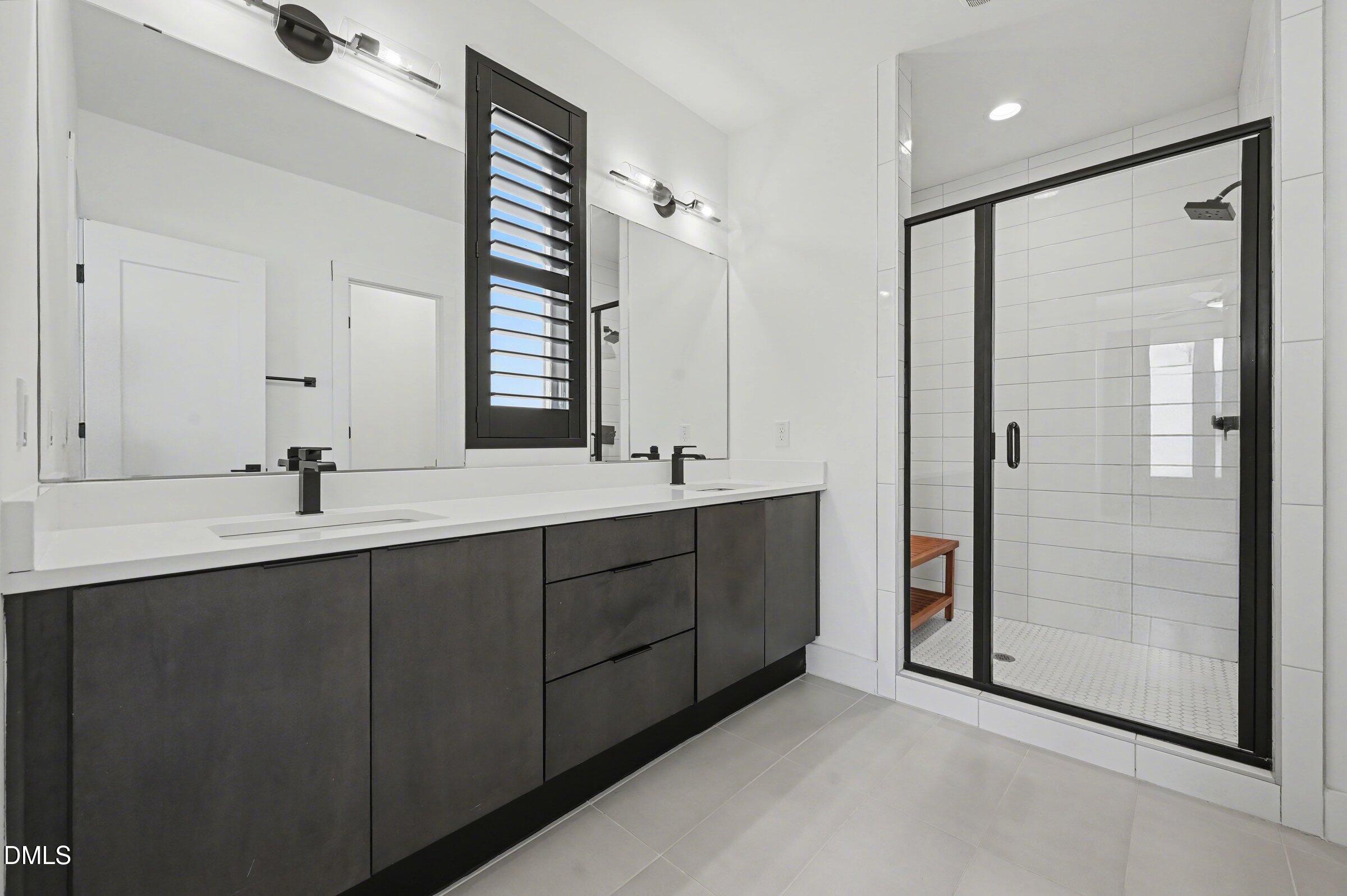 528 North Roxboro Street Durham, NC 27701 - Photo 19 of 26 a bathroom with a double vanity sink mirror and shower