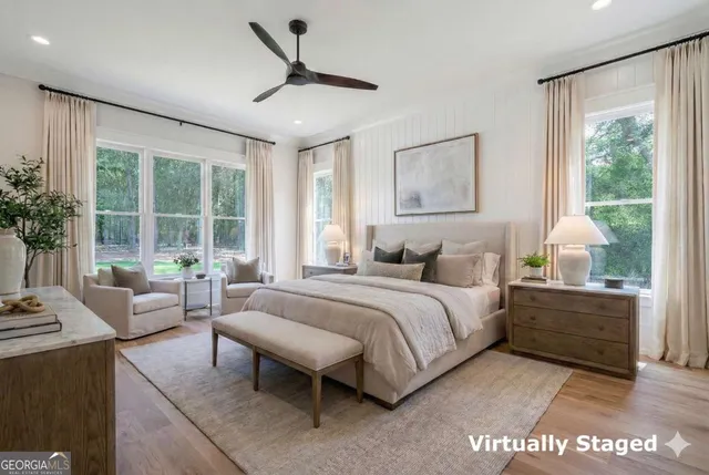 an empty room with wooden floor and glass door