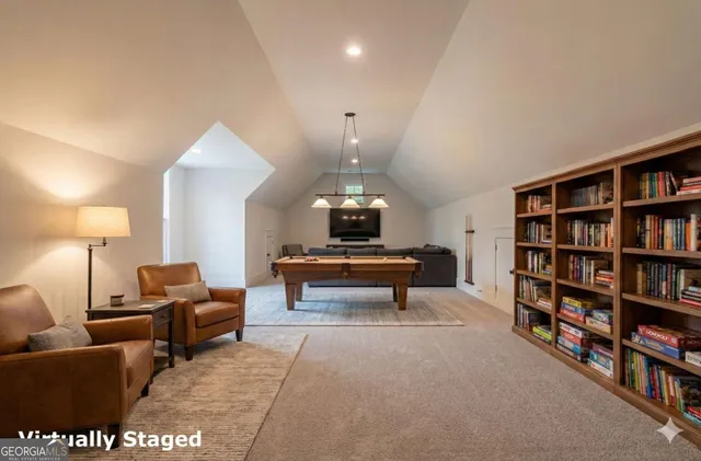 a view of an empty room with wooden floor and windows