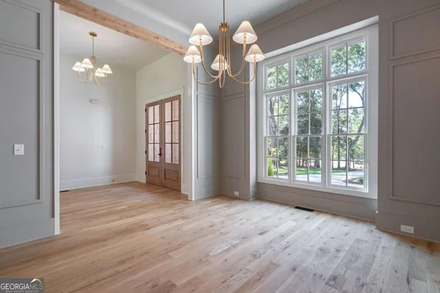 a large kitchen with stainless steel appliances a large counter top a sink and a refrigerator