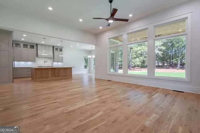 a kitchen with stove cabinets and wooden floor