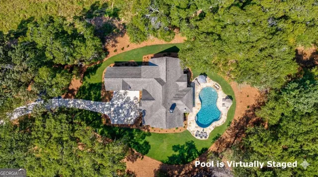 an aerial view of a house with a yard and garden