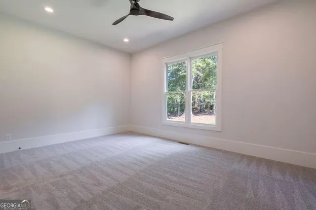 an aerial view of a house with a yard and trees