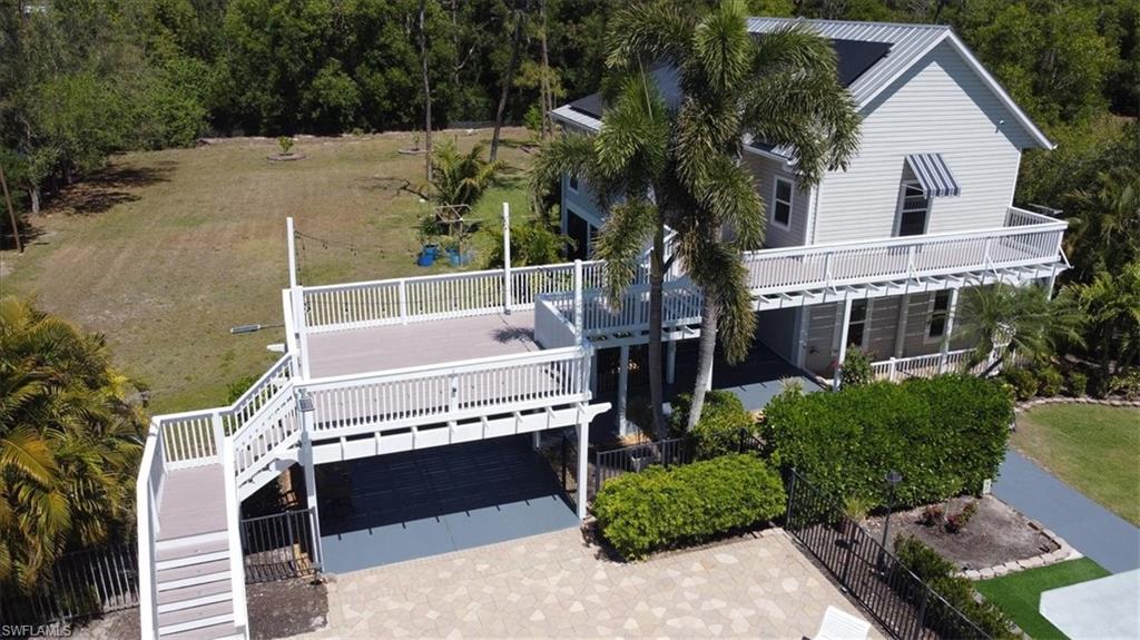 6941 Hunters Road Naples, FL 34109 - Photo 1 of 48 a view of a house with a balcony
